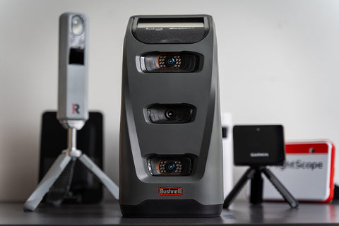 The Bushnell Launch Pro standing in front of several other golf launch monitors