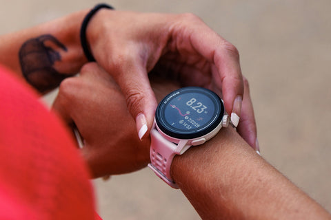 A white Coros Pace 3 on a woman's wrist with her hand on it adjusting the breadcrumb trail on the display