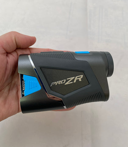 The Shot Scope Pro ZR golf rangefinder in golf reviewer Marc's hand