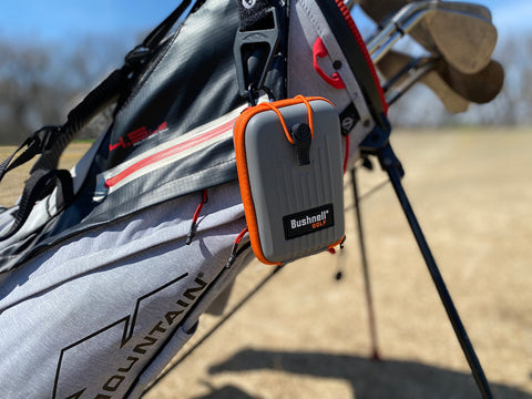 The Bushnell Pro X3+ rangefinder case hanging from Marc's golf bag