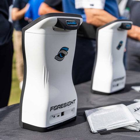 Back view of two QuadMAX golf launch monitors standing on a table at the Foresight Sports display on demo day at the 2024 PGA Show in Orlando, Fl