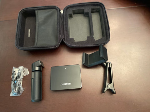 Garmin R10 case opened on a table with all the contents laid out on the around it