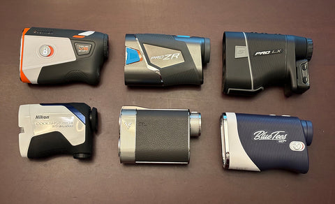 Six of the best golf rangefinders laid out on a table by golf reviewer Marc