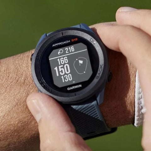The navy blue Garmin Approach S12 golf GPS watch on a golfer's wrist