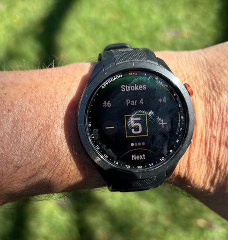 The Black 47 mm Garmin Approach S70 on Marc's wrist showing strokes for a par 4 hole at the golf course