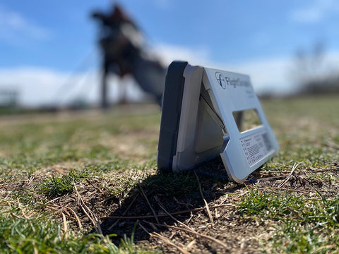 Side view of the FlightScope Mevo+ Limited Edition on grass at the golf range