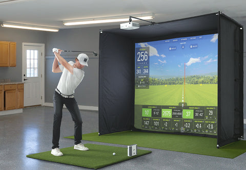 Golfer using a SkyTrak+ PlayBetter SimStudio in a basement