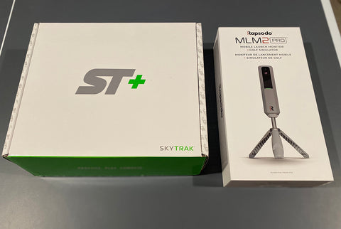 SkyTrak+ and Rapsodo MLM2PRO side by side in their product boxes