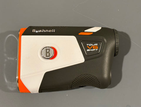 Tour V6 Shift golf rangefinder laying on a table