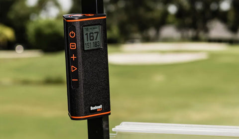 The Bushnell Wingman View attached to the pole of a golf cart by the speakers magnetic mount