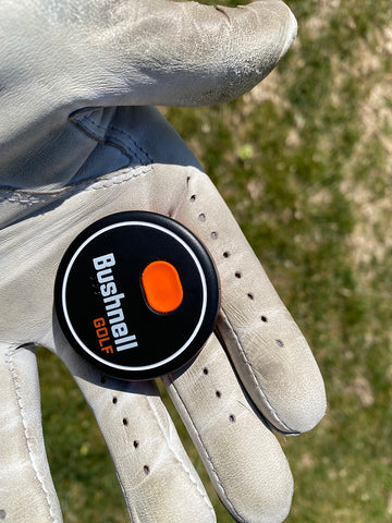 The Bushnell Wingman 2 remote in the palm of Marc's white golf-gloved hand