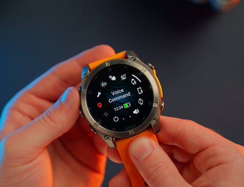 Garmin fenix 8 with Voice Command app on the watch face; held in both hands of Ryan at PlayBetter