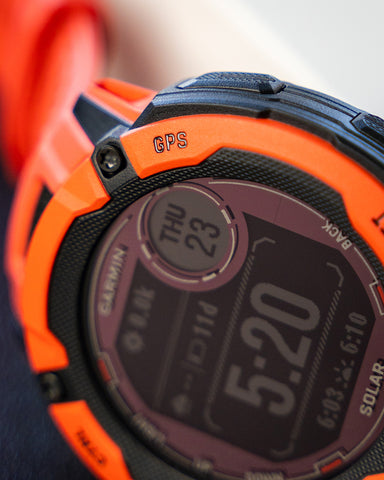 Closeup of an orange Garmin Instinct 2X Solar watch face