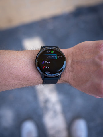 Black Garmin Venu 3 on a wrist showing fitness activities on the watch face