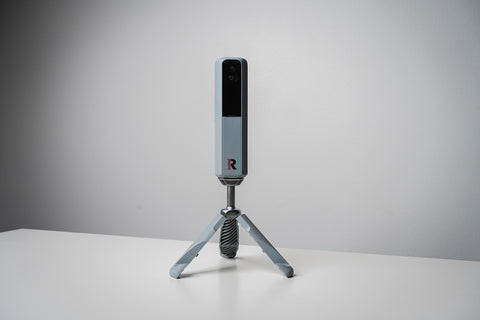 The Rapsodo MLM2PRO golf launch monitor standing upright against a light background