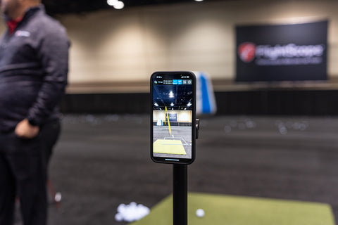 A phone on a stand with the FlightScope shot tracer on it at the 2024 PGA Show