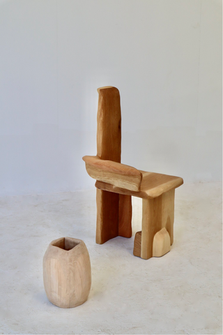 Image of two pieces of Alexis Williams. One being a chair and the other a vase both made from timber.