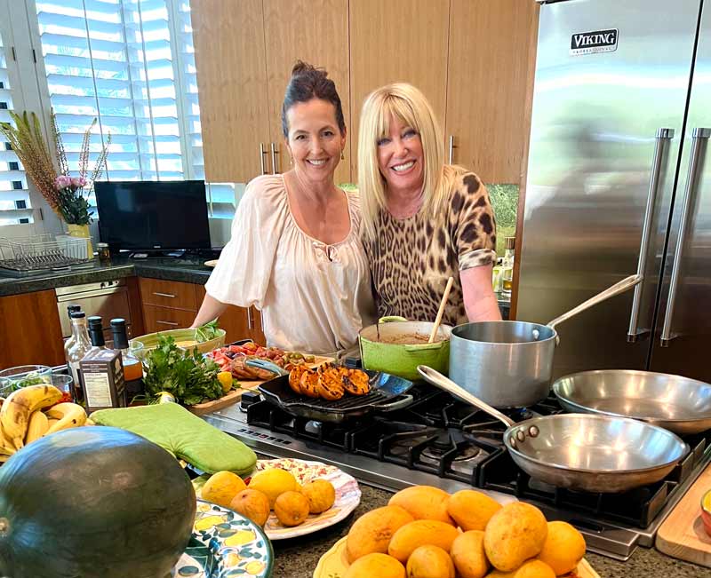 Caroline and suzanne in the kitchen with the food they've made