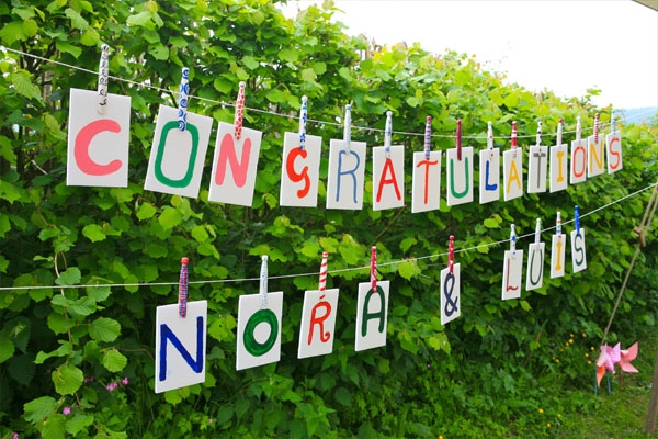 A unique wedding banner reads congratulations and is personalised with the bride and groom's name