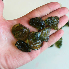 Hand full of synthetic moldavite from China