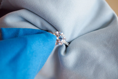 gemstone rings being cleaned with microfibre cloth