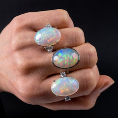 opal gemstone rings woman's hand