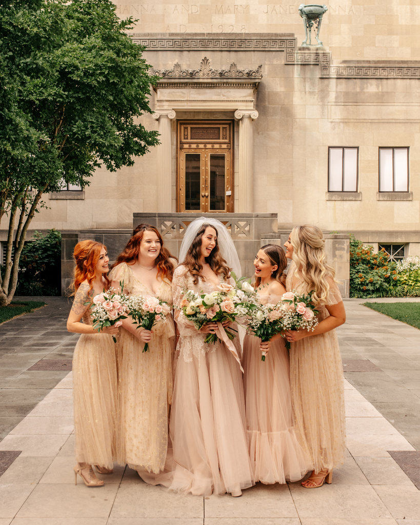 bride standing with bridesmaids 