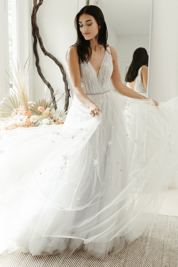 Model wearing Willowby by Watters Stars Align ball gown wedding dress