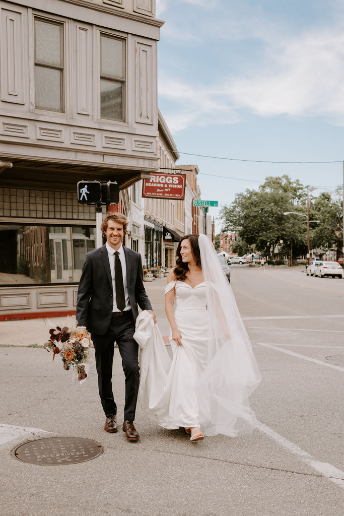 Hotel Covington bride and groom crossing the street