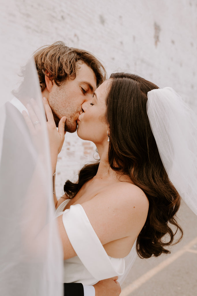 Hotel Covington bride and groom share a kiss under bride's veil