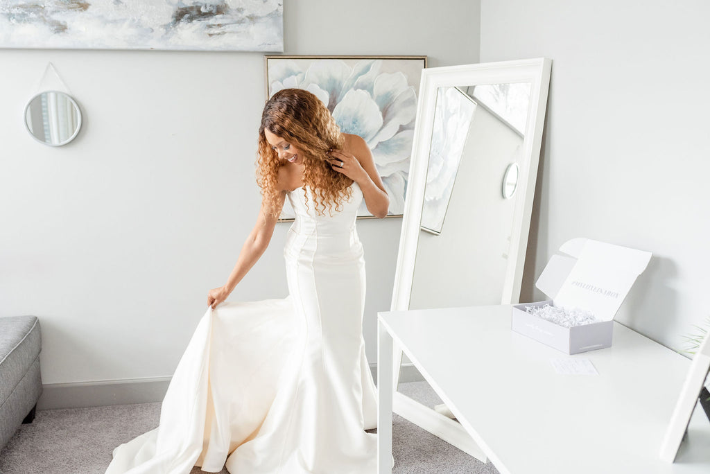 Bride trying on wedding dresses at home with Luxe in a Box