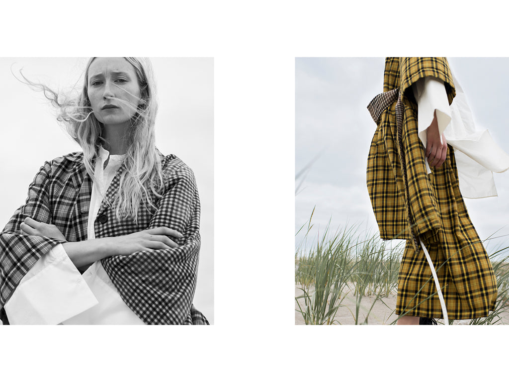 The first image is a Black and White front view of a blonde haired woman wearing a White shirt and plaid coat. Her arms are crossed. The second image is a cropped side view of the same woman wearing a Yellow and Black plaid coat and pant with a White cotton shirt underneath.