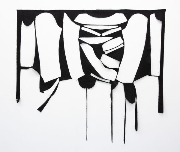 artwork made of fabric with cut outs from cutting a garment. negative of a garment