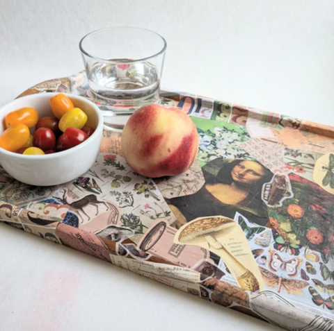 Decoupaged tray with a glass of water, bowl of cherry tomatoes, and peach on top