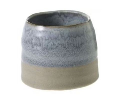 A planter that is slightly rounded at the top, with a blue-gray wash on the top half and a matte gray bottom half