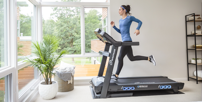 Woman running on a Treadmill in the living room