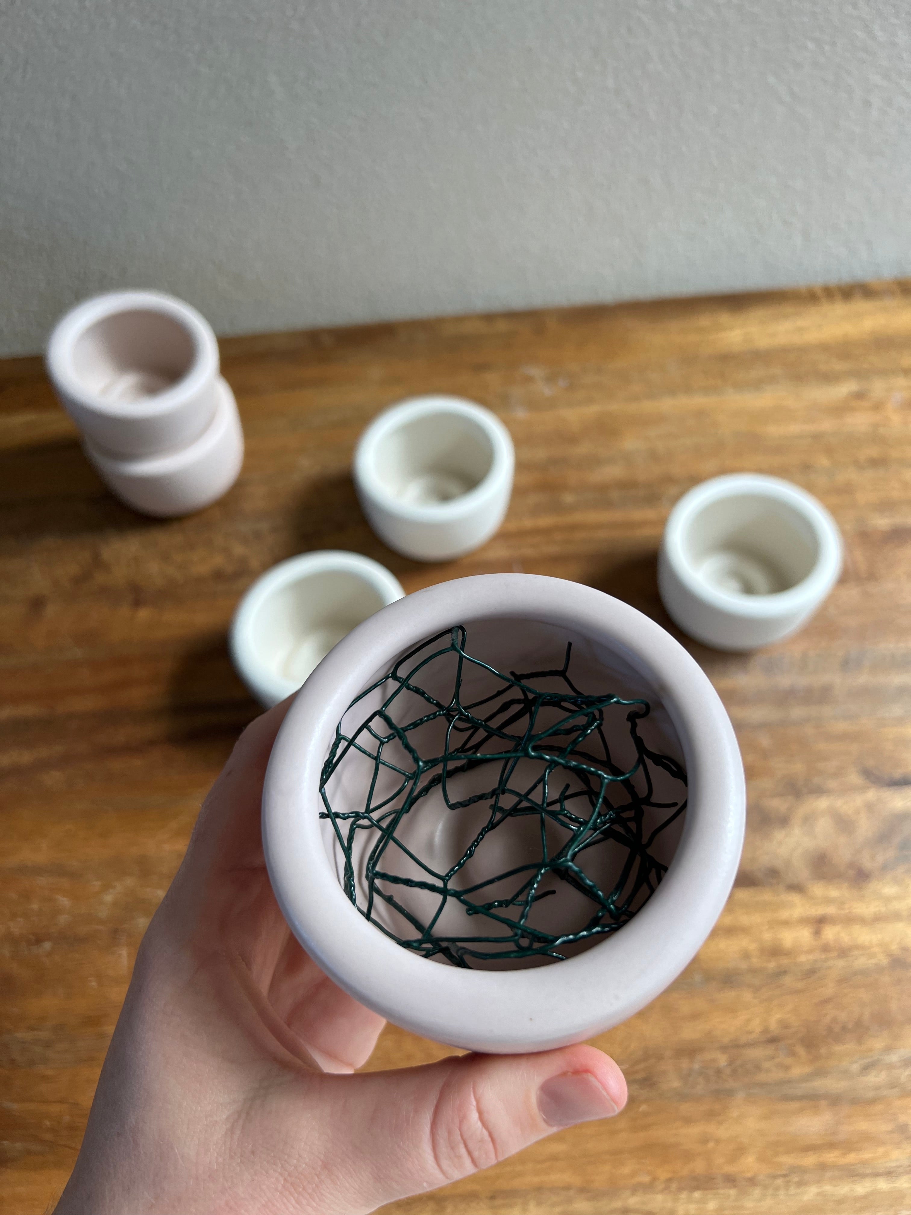 small white ceramic bowl with chicken wire rolled up inside