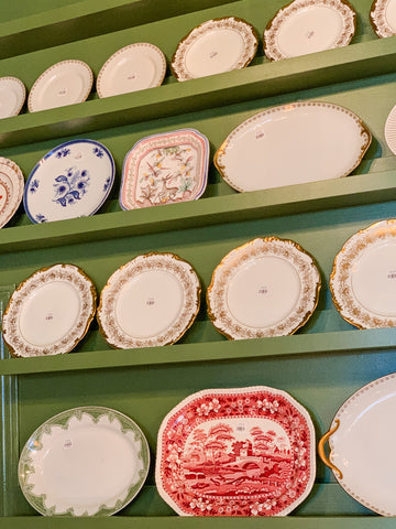 Vintage china platter wall at Honeychurch Interiors