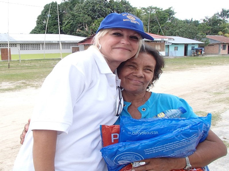 Rotary Club of Key Biscayne Foundation volunteer with a resident of one of the Peruvian communities harmed by flooding