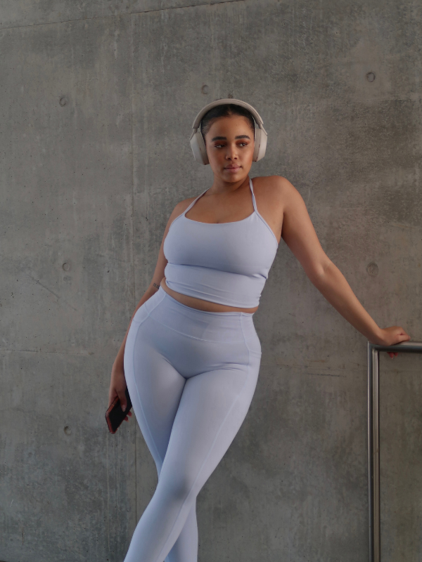 @therealmiccy wears the halter-neck Suki Tank styled with the Activluxe pocket leggings