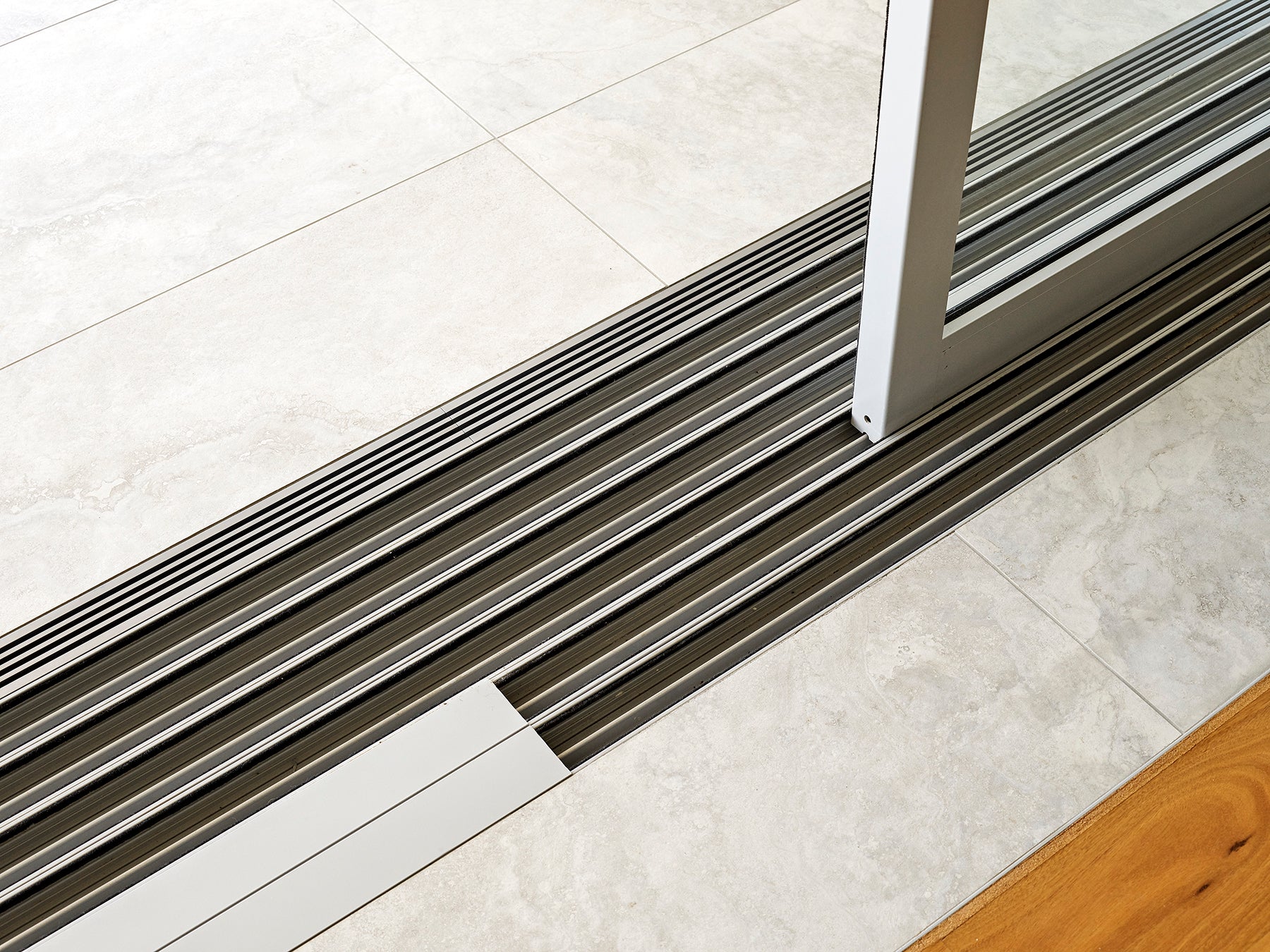 Aquabocci’s Champagne drainage grate used by Gavin Maddock in beachside architectural design.