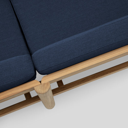 A studio photo of Haven Sectional Sunbrella Indigo / Six Piece / Teak Armrest