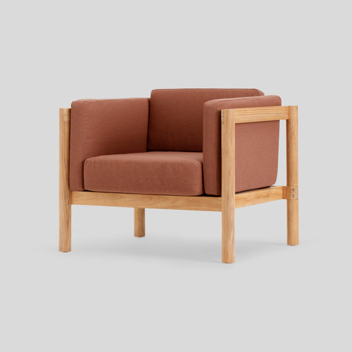 A studio photo of Haven Chair Sunbrella Rust / Cushion Arm