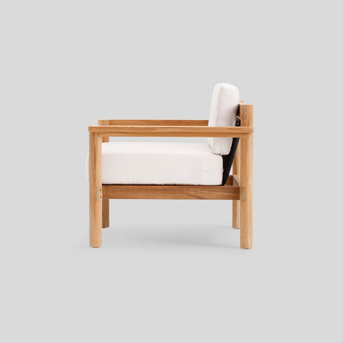 A studio photo of Haven Chair Sunbrella Canvas / Teak Armrest