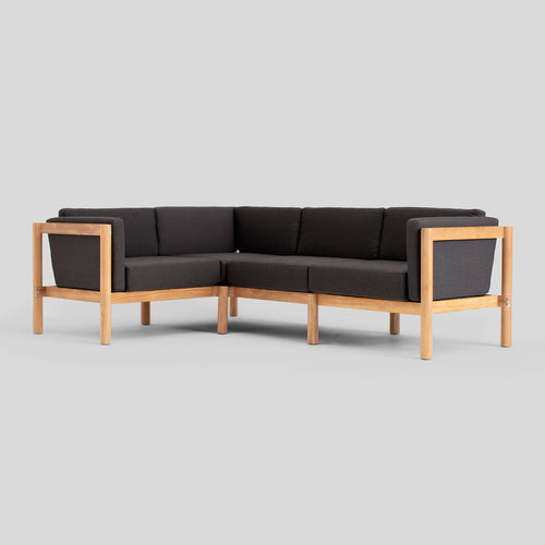 A studio photo of Haven Sectional Sunbrella Coal / Four Piece / Cushion Arm