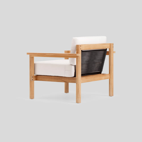 A studio photo of Haven Chair Sunbrella Canvas / Teak Armrest