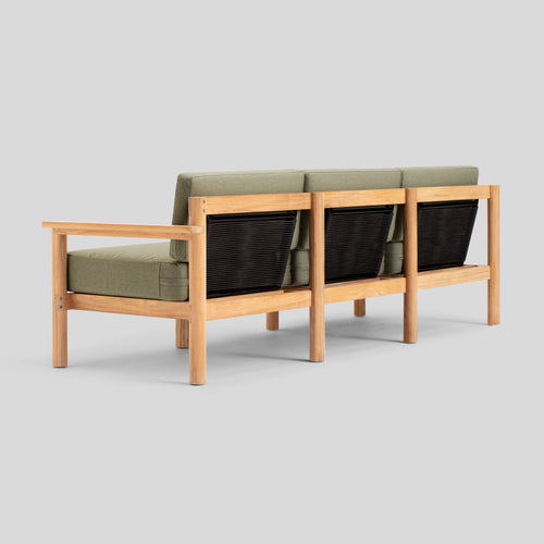 A studio photo of Haven Sofa Sunbrella Leaf / Teak Armrest