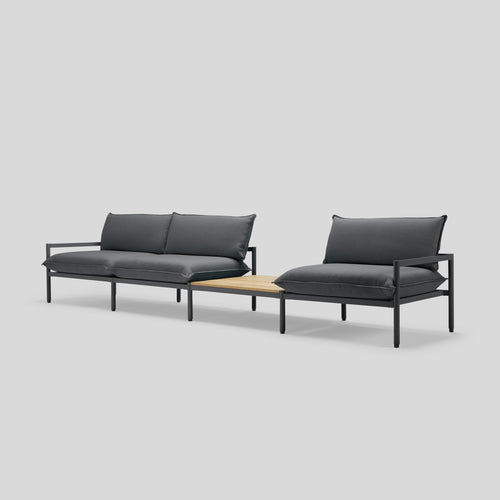 A studio photo of Terra Sofa with In-line Table Charcoal / Table