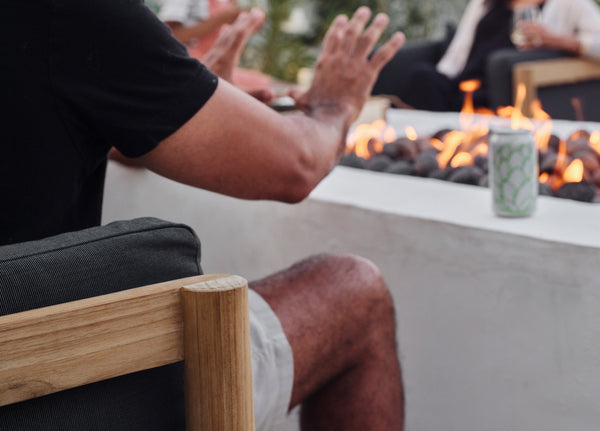 Man warming hands near fire