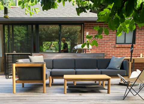 Outdoor sectional with gray cushions against modern home